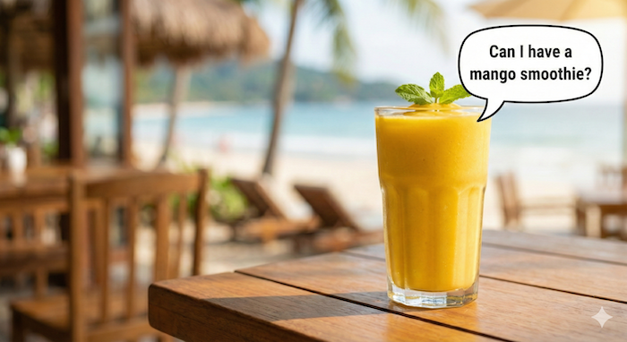 Ordering a mango smoothie at a beach cafe. (ビーチカフェでマンゴースムージーを注文)